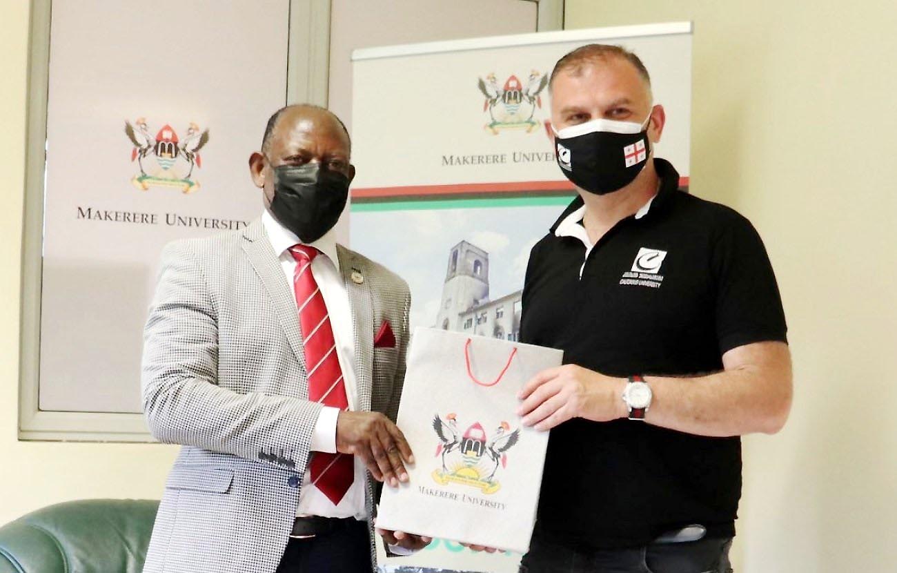 The Vice Chancellor, Prof. Barnabas Nawangwe (L) hands over an assortment of souvenirs to Prof. Kakha Shengelia (R) during their meeting on 14th May 2021, CTF1, Makerere University.