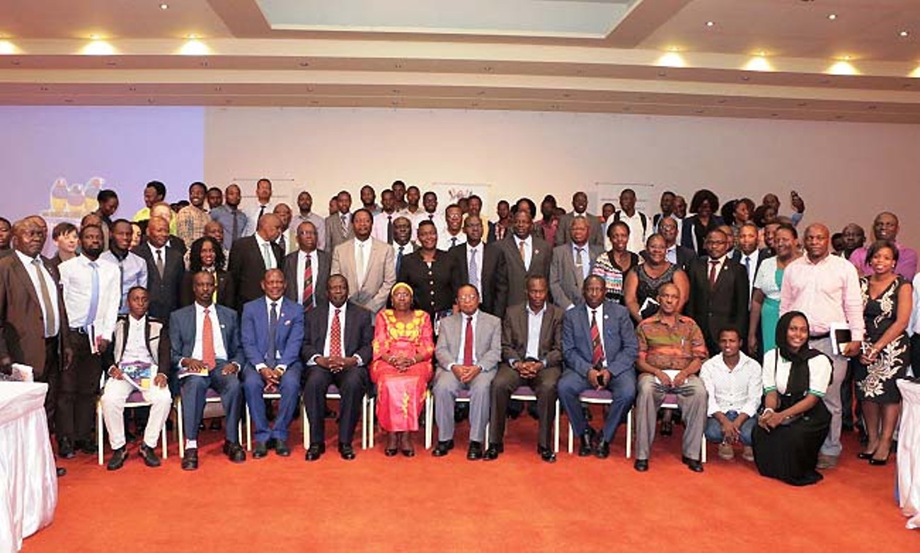 Guest of Honour & Minister of Health-Hon. Dr. Jane Ruth Aceng (C), flanked by Chancellor-Prof. Ezra Suruma (4th R), Chairperson Council-Eng. Dr. Charles Wana-Etyem (4th L), Vice Chancellor-Prof. Barnabas Nawangwe (3rd L), Chairperson BoT, SAIU-H.E. King Caesar Augustus Mulenga (3rd R), Principal CHS-Dr. Charles Ibingira (2nd R), Book Author-Mr. Nelson Twinamasiko with other officials and delegates at the First International NCD Symposium official opening, 12th February 2018, Speke Resort Munyonyo, Kampala.