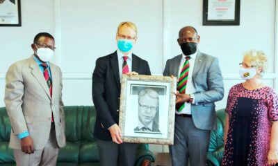 The Vice Chancellor, Prof. Barnabas Nawangwe (2nd R) presents a portrait to outgoing Ambassador of Sweden to Uganda, H.E. Per Lindgärde (2nd L) during the latter's farewell visit to Makerere University on 21st June 2021 as Dr. Gity Behravan (R) and Prof. Buyinza Mukadasi (L) witness.