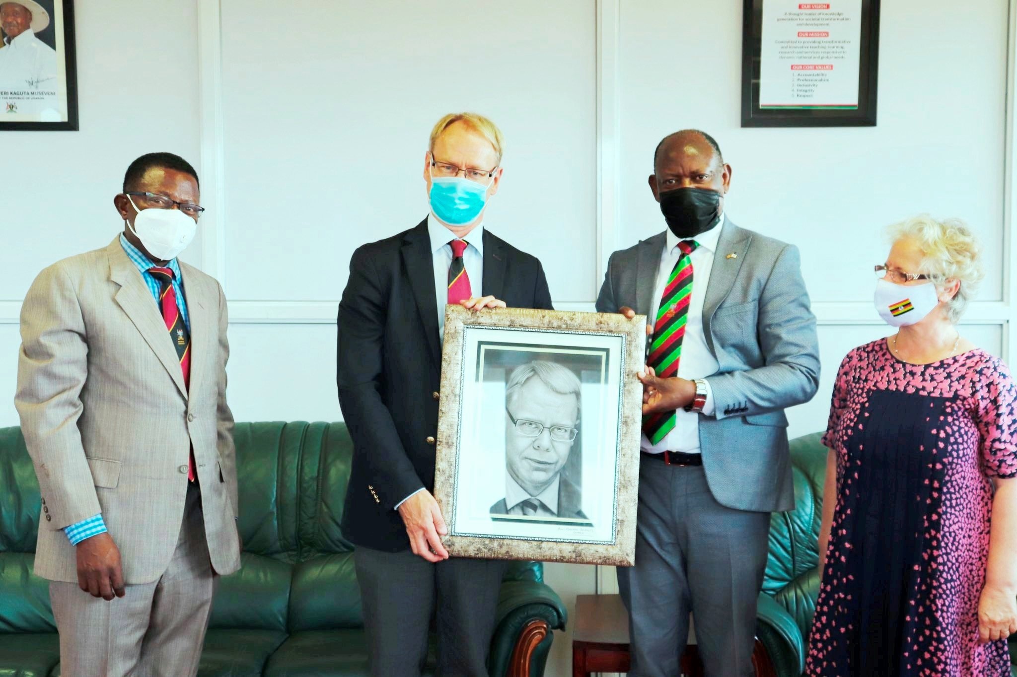 The Vice Chancellor, Prof. Barnabas Nawangwe (2nd R) presents a portrait to outgoing Ambassador of Sweden to Uganda, H.E. Per Lindgärde (2nd L) during the latter's farewell visit to Makerere University on 21st June 2021 as Dr. Gity Behravan (R) and Prof. Buyinza Mukadasi (L) witness.