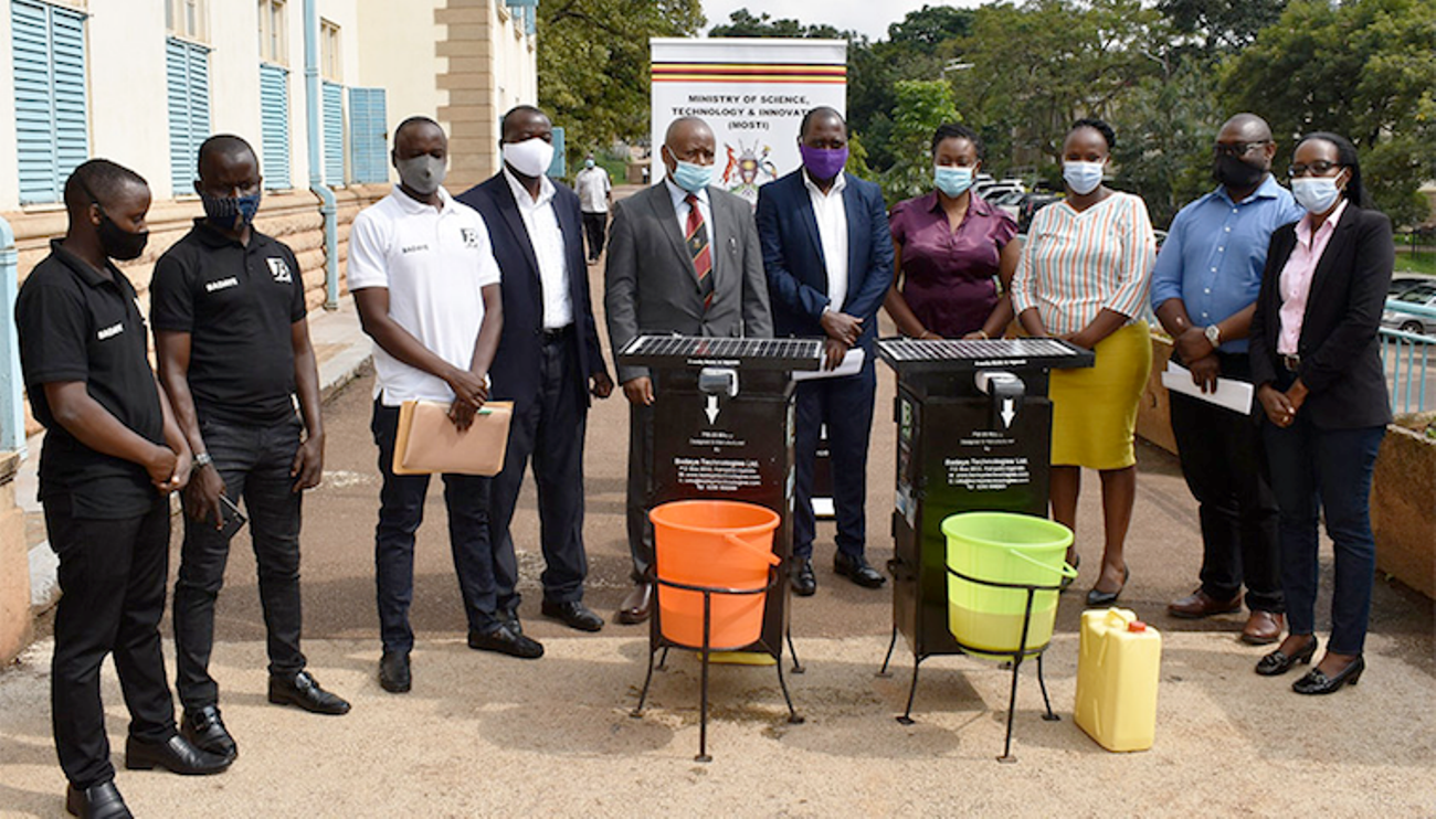 The green low-cost touchless hand wash kit being unveiled.