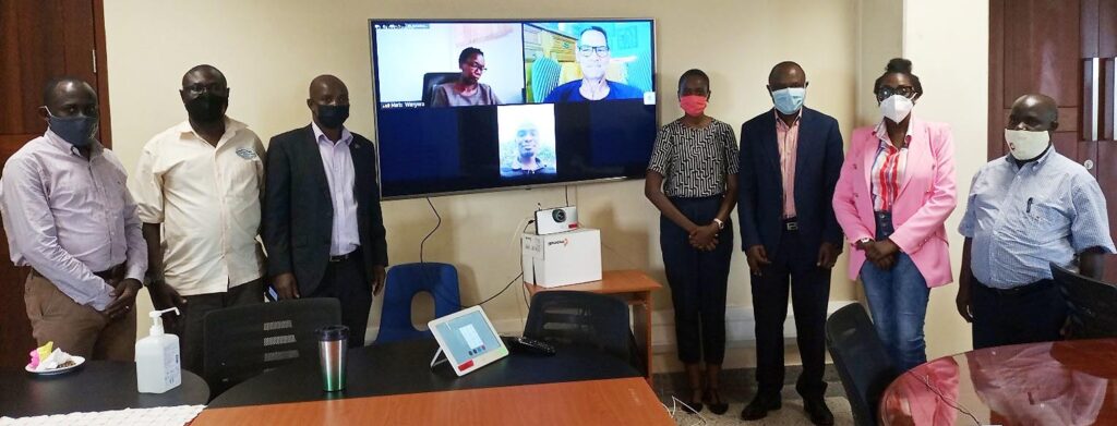Assoc. Prof. Eria Hisali (3rd R) and Assoc. Prof. Edward Bbaale (3rd L) pose with participants both physical and virtual during the launch of the IGE Programme on 4th June 2021, CTF2, Makerere University.