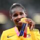 Peruth Chemutai shows off her Gold Medal after winning the Women's 3,000m Steeplechase at the Olympics in Tokyo, Japan on 4th August 2021. Photo: Vincenzo PINTO/AFP