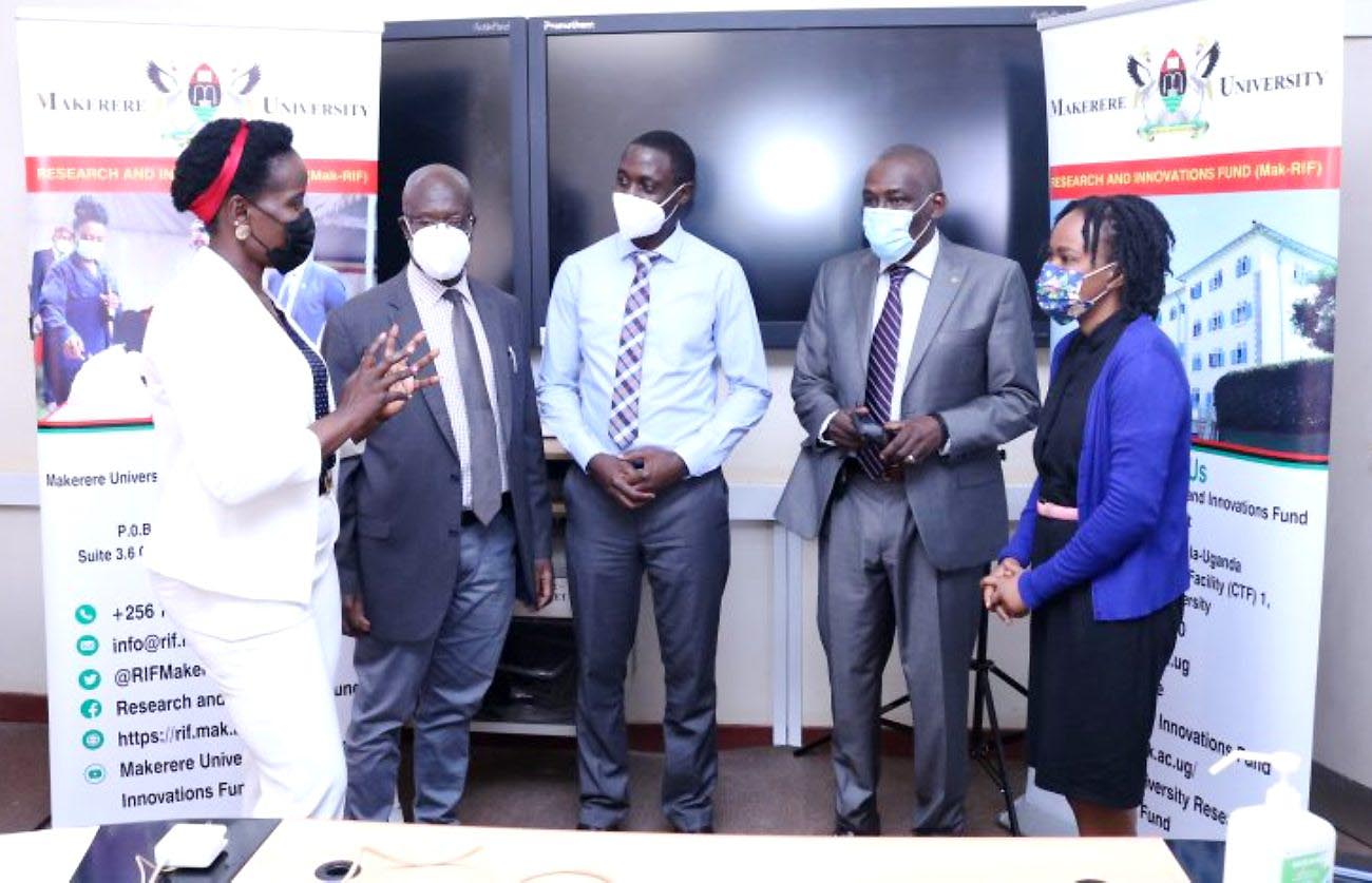 The Study PI-Prof. Nelson Sewankambo (2nd R) and members of his team; Dr. Daniel Semakula (C) and Dr. David Kaawa-Mafigiri (2nd R) chat with Mak-RIF’s Ms. Harriet Adong (L) after the research dissemination on 3rd August 2021, College of Health Sciences, Makerere University.