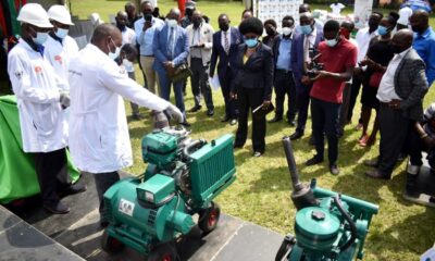 The Minister of Science, Technology and Innovation, Hon. Dr. Monica Musenero (Centre), Vice Chancellor, Prof. Barnabas Nawangwe and other guests listen to M/S Kevoton’s representative explain how one the #MakDieselPower engine prototypes works during the launch on 19th August 2021, Freedom Square, Makerere University.
