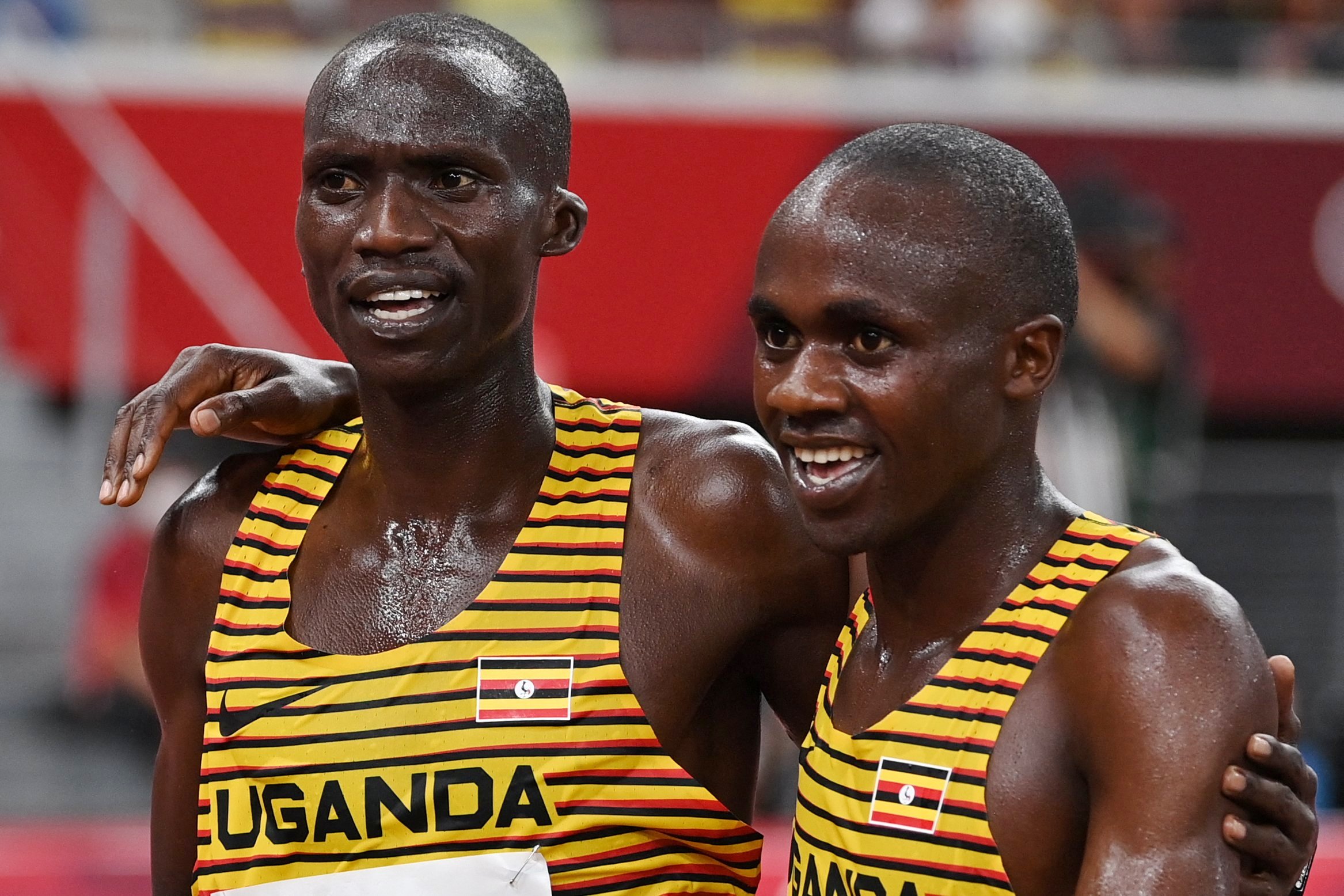 Joshua Cheptegei (L) and Jacob Kiplimo (R) embrace after finishing second and third respectively in the men's 10000m final of the Tokyo 2020 Olympic Games, 30th July 2021. Photo: AFP