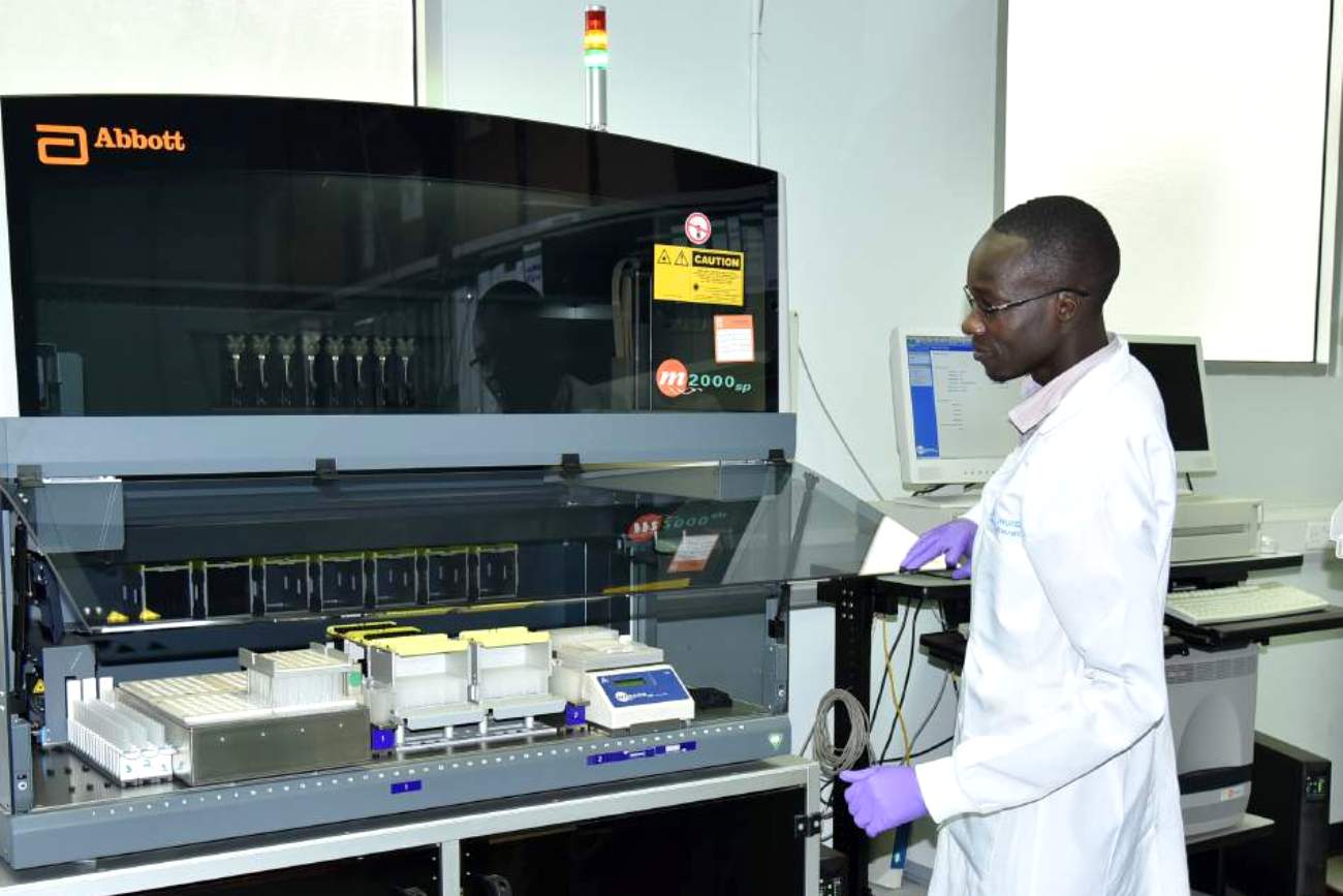 One of the staff uses the Abbott m2000 RealTime System in the Core Laboratory (CL), IDI, Makerere University, Kampala Uganda, East Africa.