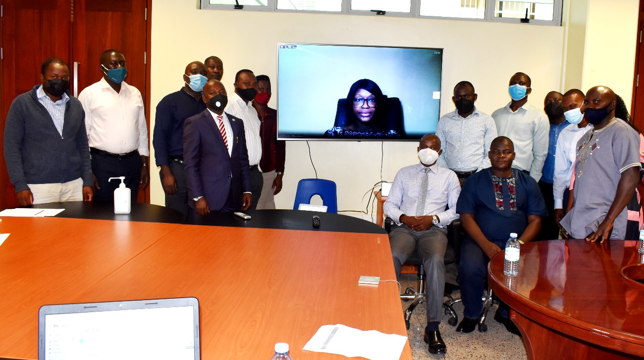 EfD-Mak Centre Director Prof. Edward Bbaale and research fellows pose for a group photograph with the facilitator Dr. Byela Tibesigwa on screen during the seminar on 7th September 2021, CTF2, Makerere University.