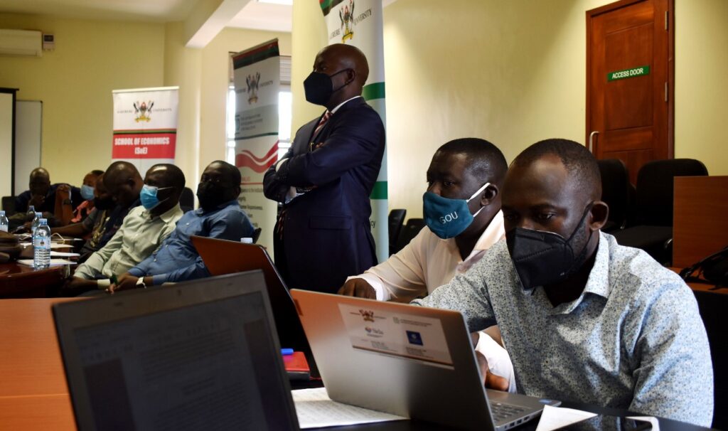 Some of the research fellows who attended the seminar physically follow proceedings intently.