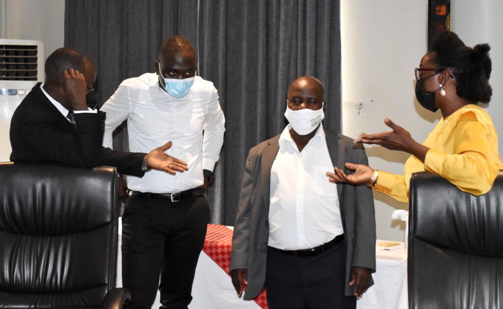 Mr. Peter Babyenda (L) interacts with some trainees during a break. 