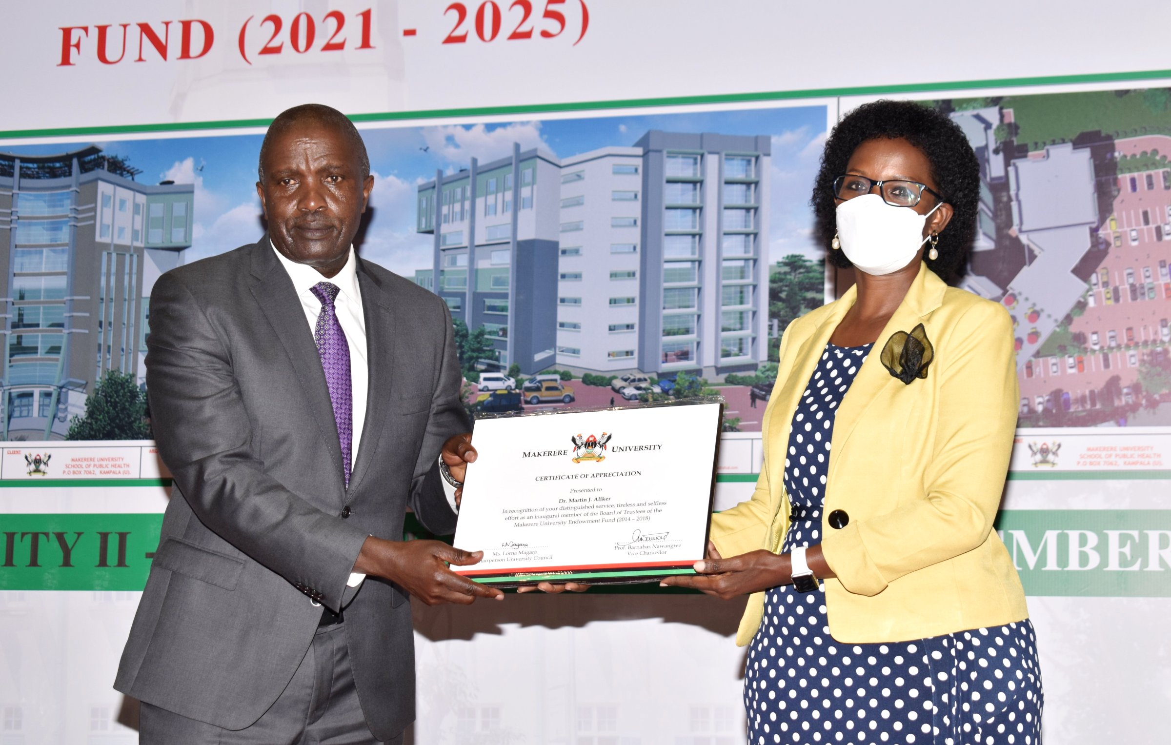 The Chairperson of Council, Mrs. Lorna Magara (R) hands over a Certificate of Appreciation to Mr. Barnabas Tumusingize (L) who received it on behalf of Outgoing Chairperson, Dr. Martin J. Aliker at the MakEF Board Inauguration on 30th September 2021, CTF2 Auditorium, Makerere University.