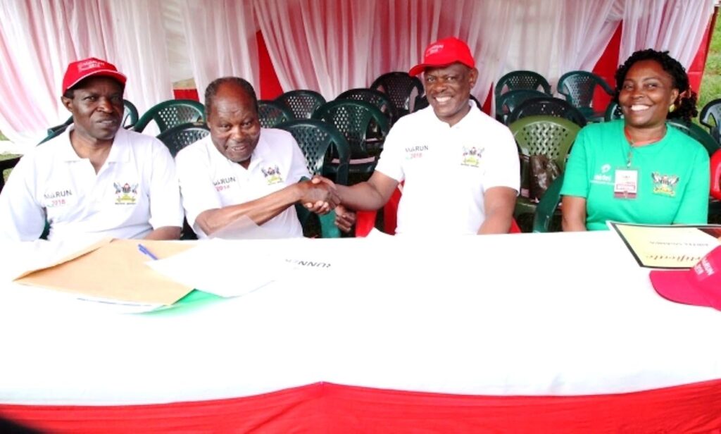 Dr. Martin Aliker (2nd L) shakes hands with the Vice Chancellor, Prof. Barnabas Nawangwe (2nd R) at the successful conclusion of the Second Edition of the Makerere University Endowment Fund (MakEF) Run (MakRun) on Sunday 25th March 2018 as Prof. William Bazeyo (L) and Dr. Florence Nakayiwa (R) witness. 