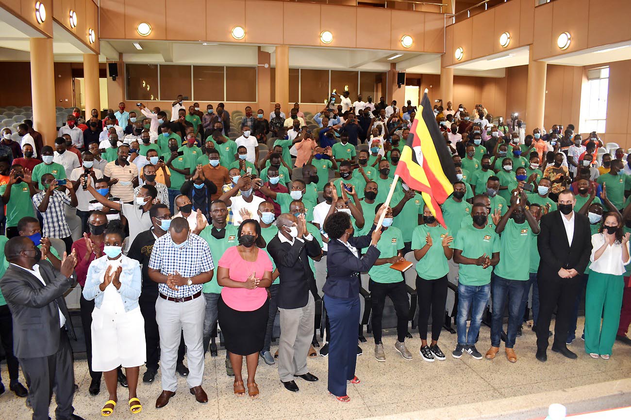 The Acting Vice Chancellor and DVCFA-Dr. Josephine Nabukenya (holding flag) flanked by Prof. Bernard Bashaasha (to her left), coordinators, students and CEO Agrostudies-Mr. Yaron Tamir (2nd R) and his Deputy during the flag of on 13th October 2021, CTF2 Auditorium, Makerere University.
