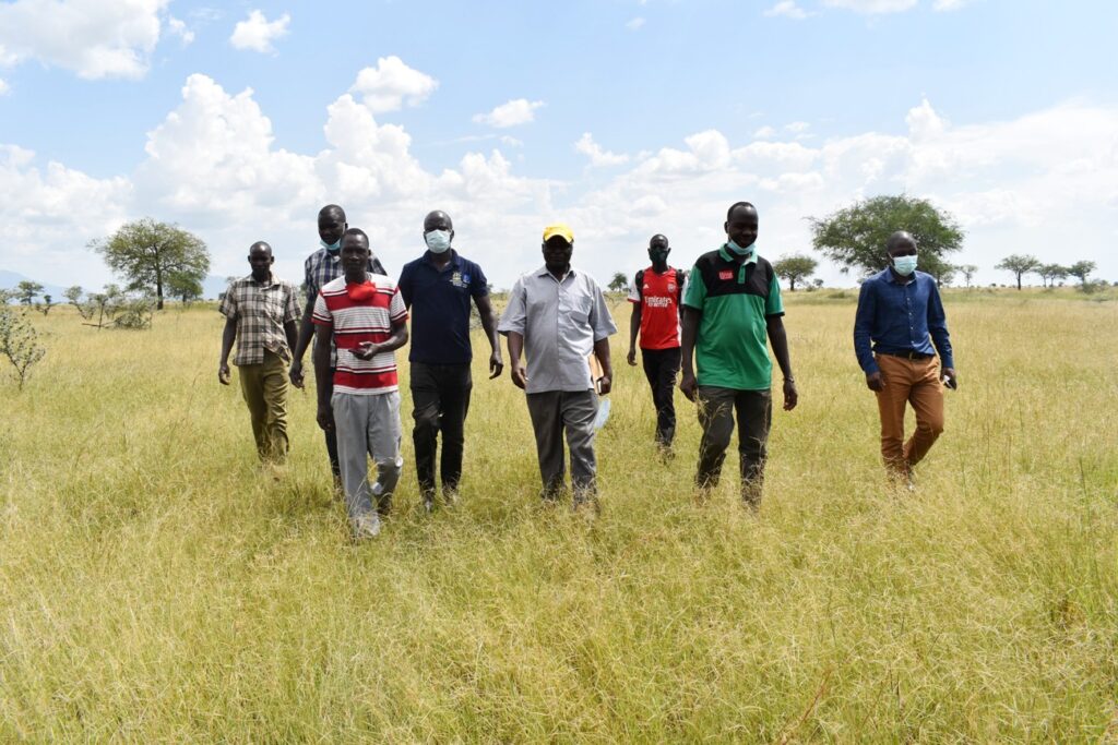 Prof. Denis Mpairwe (in yellow cap), with Napak and Moroto District as well as Poron Sub-County  officials tour the allocated project site.