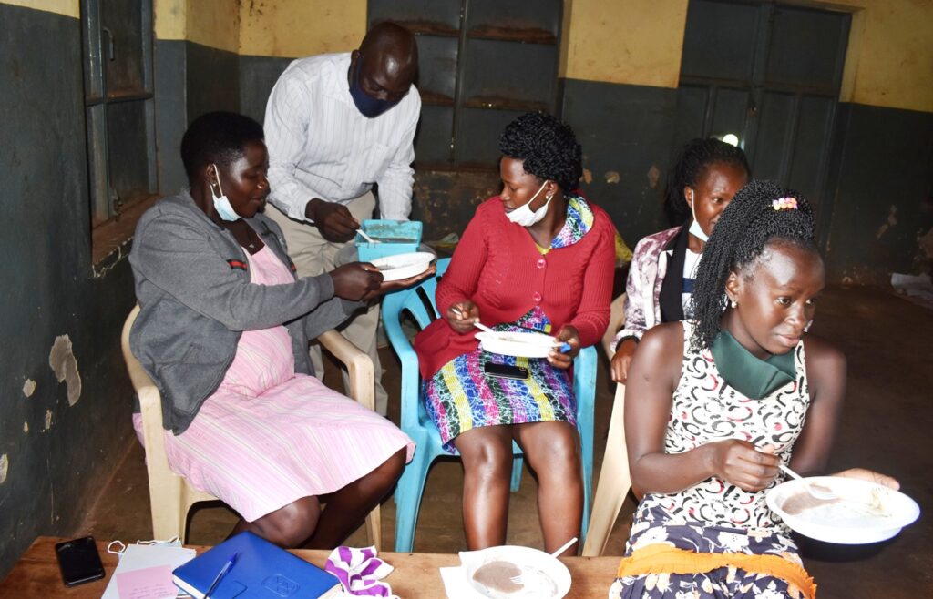 Some of the participants taste the porridge.