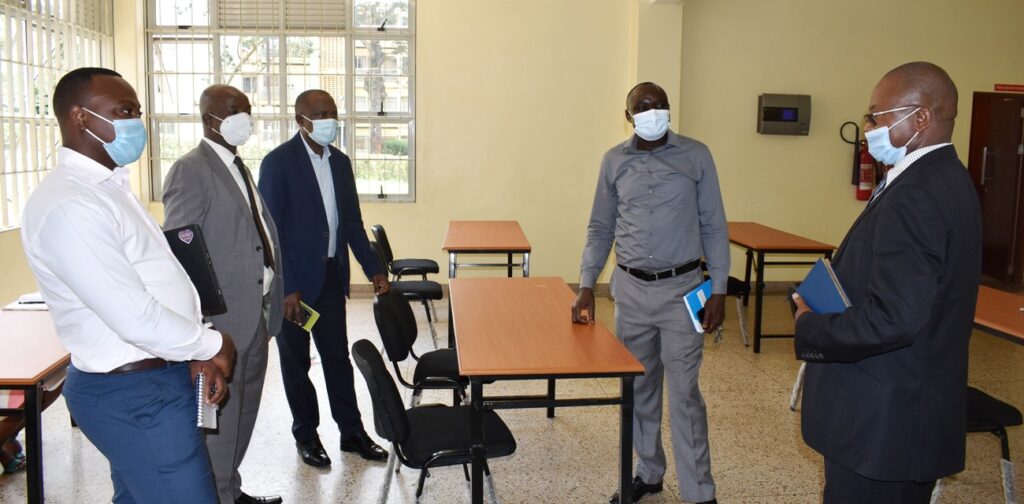 Assoc. Prof. Eria Hisali (C), Prof. Edward Bbaale (2nd L), Dr. Willy Kagarura (R) and other officials inspect some of the procured furniture.