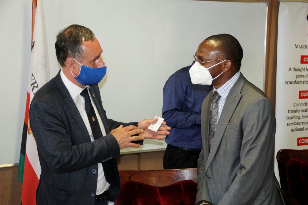 Dr. Umar Kakumba (R) and Prof. Attila Szabó (L) chat after the MoU signing ceremony.