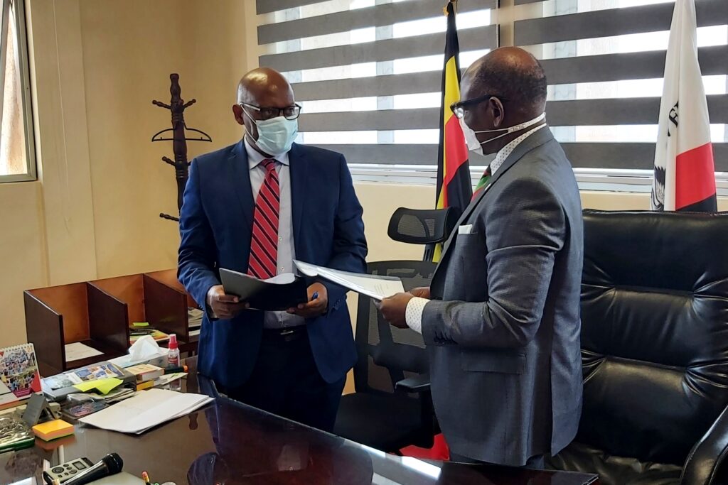 Prof. Barnabas Nawangwe (R) and Mr. Cephas Birungi Kagyenda (L) exchange the signed MoU.