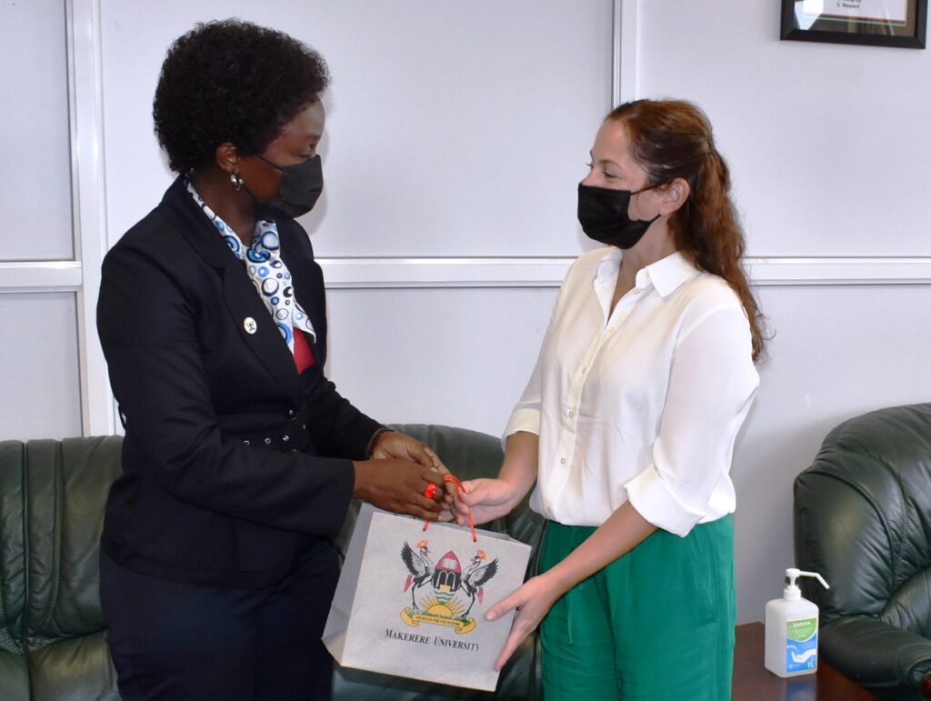 Assoc. Prof. Josephine Nabukenya (L) hands over Mak souvenirs to the Deputy CEO Agrostudies (R) during the courtesy call. 