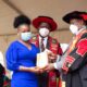 The Vice Chancellor, Prof. Barnabas Nawangwe (R) presents a plaque to one of the award recipients as the Principal, Prof. Waswa Balunywa (C) witnesses during the 15th MUBS Graduation Ceremony, 1st October 2021, Nakawa Uganda.
