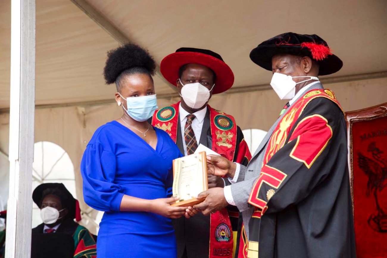 The Vice Chancellor, Prof. Barnabas Nawangwe (R) presents a plaque to one of the award recipients as the Principal, Prof. Waswa Balunywa (C) witnesses during the 15th MUBS Graduation Ceremony, 1st October 2021, Nakawa Uganda.