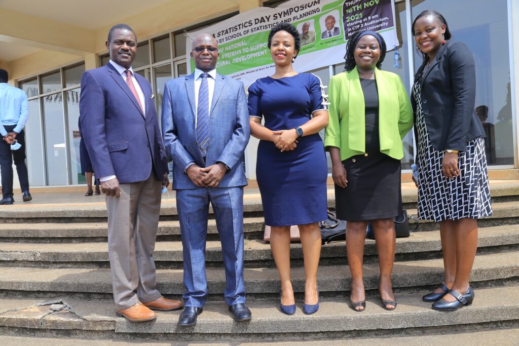 The Dean School of Statistics and Planning (SSP) Dr. James Wokadala (2nd L) poses for a group photo with colleagues from SSP at the Symposium.