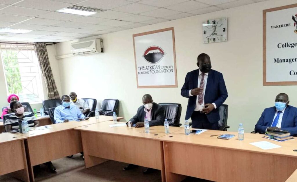 The Dean, School of Business, Dr. Akileng Godfrey (standing) makes his remarks. 