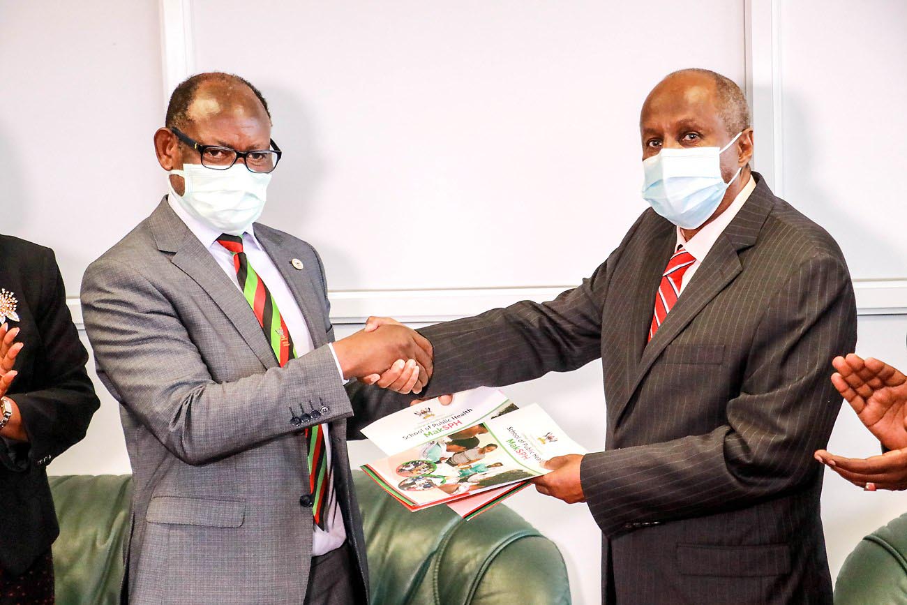 The Vice Chancellor, Prof. Barnabas Nawangwe (L) exchanges the signed MoU with Prof. Hassan Omar Mahadalle, the Rector of Somalia National University (R) after the ceremony on 21st November 2021, CTF1, Makerere University.