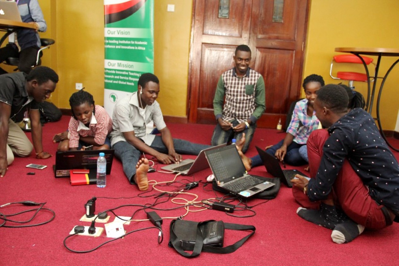 Terrydon Wamboga (L) with other innovators at a hackathon. Photo credit: RAN.