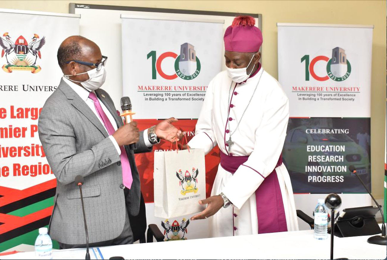 Prof. Barnabas Nawangwe (L) hands over the Love Gift mobilised from members of the Makerere University Community of all denominations to His Grace The Archbishop Dr. Stephen Kaziimba Mugalu (R) on 20th December 2021.