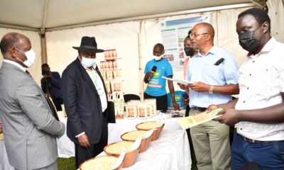 Prof. Phinehas Tukamuhabwa (2nd R) showcases improved soybean varieties to the PS MAAIF, Maj. Gen. David Kasura Kyomukama (2nd L) and the Vice Chancellor, Prof. Barnabas Nawangwe (L) during Mak-RIF CAES Open Day held on 14th December 2021.