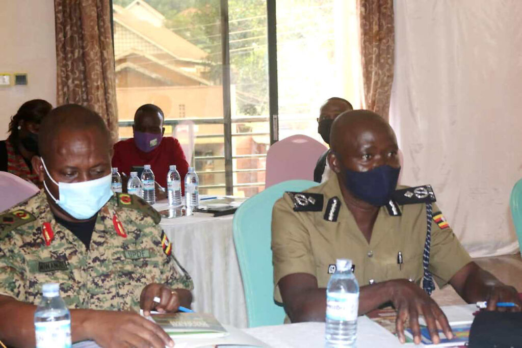 The Commissioner of Community Policing, UPF, ACP Anatoli Muleterwa (R) and UPDF's Muwanguzi (L) listen to proceedings during the KGYTEP Project Stakeholder Engagement.