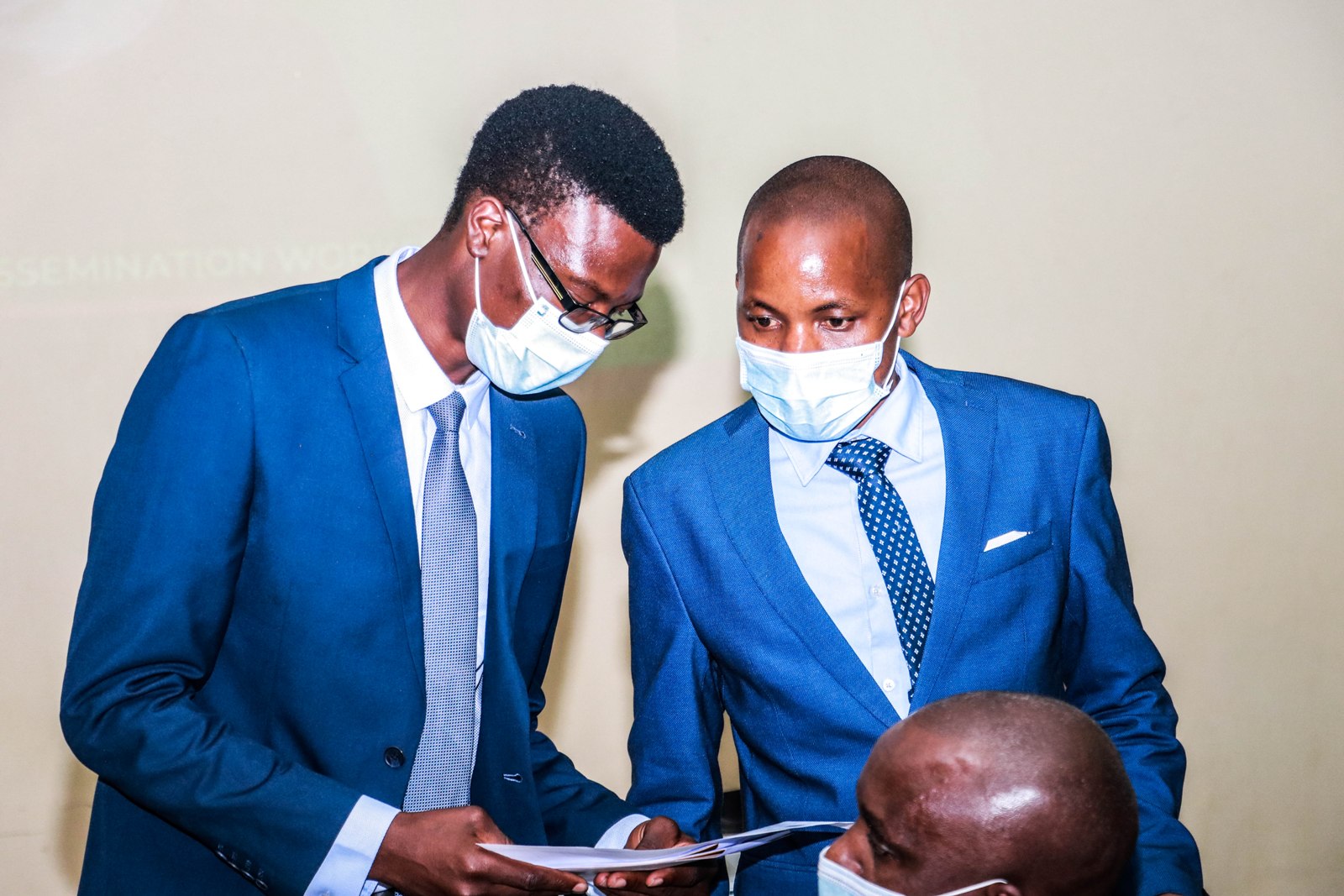 Dr. Rawlance Ndejjo, the SPICES Project Coordinator (L) consults with the PI Dr. Geofrey Musinguzi (R) at the Dissemination workshop held on December 8th 2021 at Colline Hotel, Mukono.