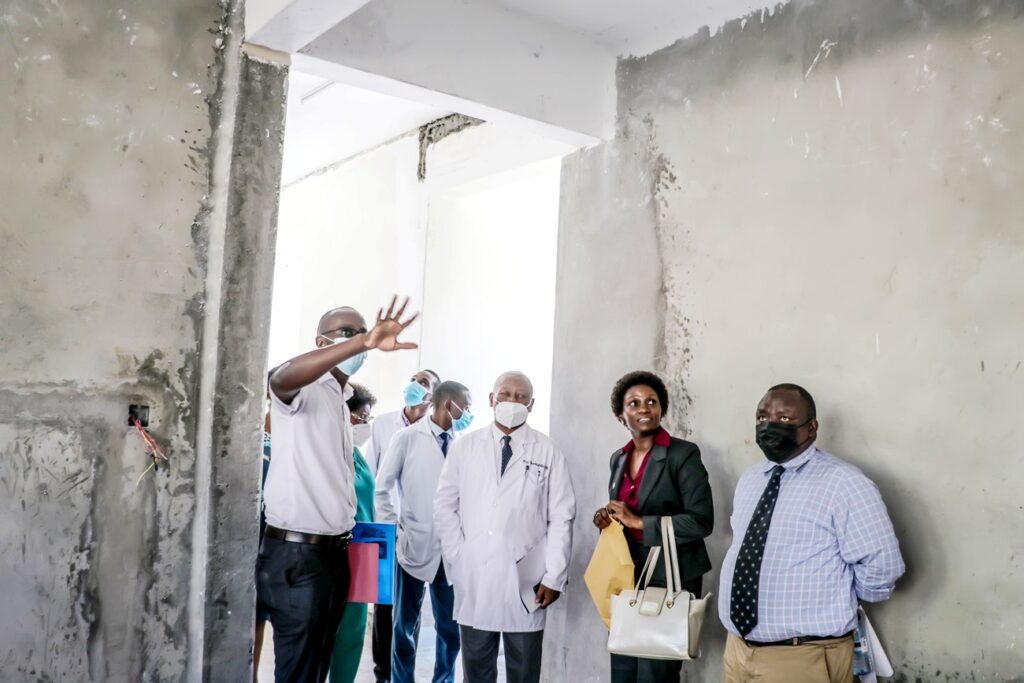 The DVCFA (2nd R), Dr. Josaphat Byamugisha (3rd R), Mr. Paul Agaba (R), Estates and Works Officials and University Hospital Staff tour part of the Hospital under. refurbishment.