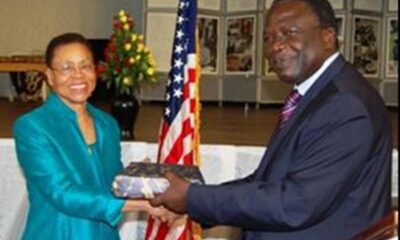 Dr. Shelby Lewis (L) receives a gift from the Chairperson of Makerere University Council Eng. Dr. Charles Wana Etyem after she delivered her lecture on "The Fulbright Scholarship in Africa during President Barack Obama's Administration" at Makerere University on 24th February 2012.