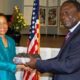 Dr. Shelby Lewis (L) receives a gift from the Chairperson of Makerere University Council Eng. Dr. Charles Wana Etyem after she delivered her lecture on "The Fulbright Scholarship in Africa during President Barack Obama's Administration" at Makerere University on 24th February 2012.