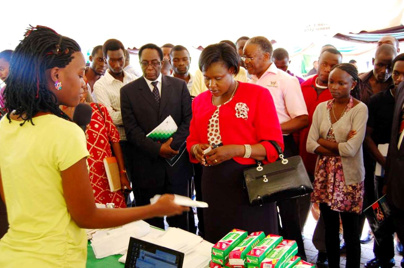 A student exhibiting MAKA Pads explains to Hon. Jessica Alupo (in red) standing next is Prof. Ddumba-Ssentamu, during the 2nd Annual CEDAT Open Day on 6th October 2012.