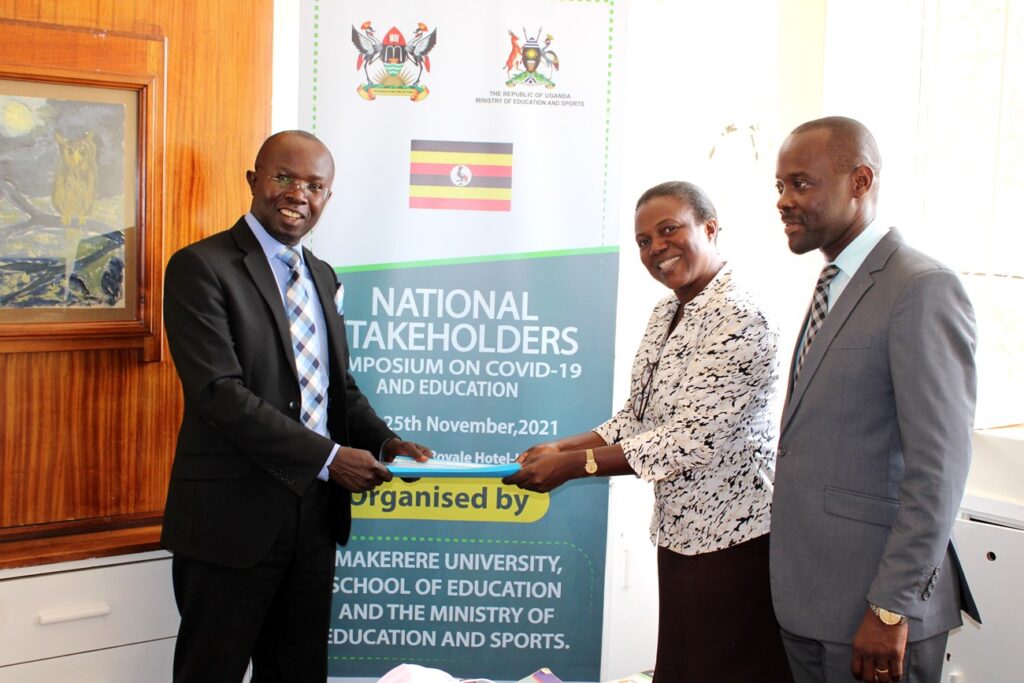 Dr. Nambi Rebecca (C) hands over some of the Department files to Dr. Muhammad Kiggundu Musoke (L) as Dr. Mathias Mulumba (R) witnesses on 13th January 2022, CEES, Makerere University. 