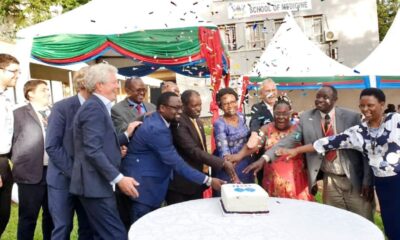 The Minister of Health-Hon. Dr. Jane Ruth Aceng (5th R) assisted by DVCFA-Prof. William Bazeyo (6th R), Director MLI-Dr. Bruce Kirenga (7th R) and other officials cuts cake at the Inauguration on 30th April 2019, Deans Gardens, CHS, Makerere University. Photo credit: Twitter/@JaneRuth_Aceng