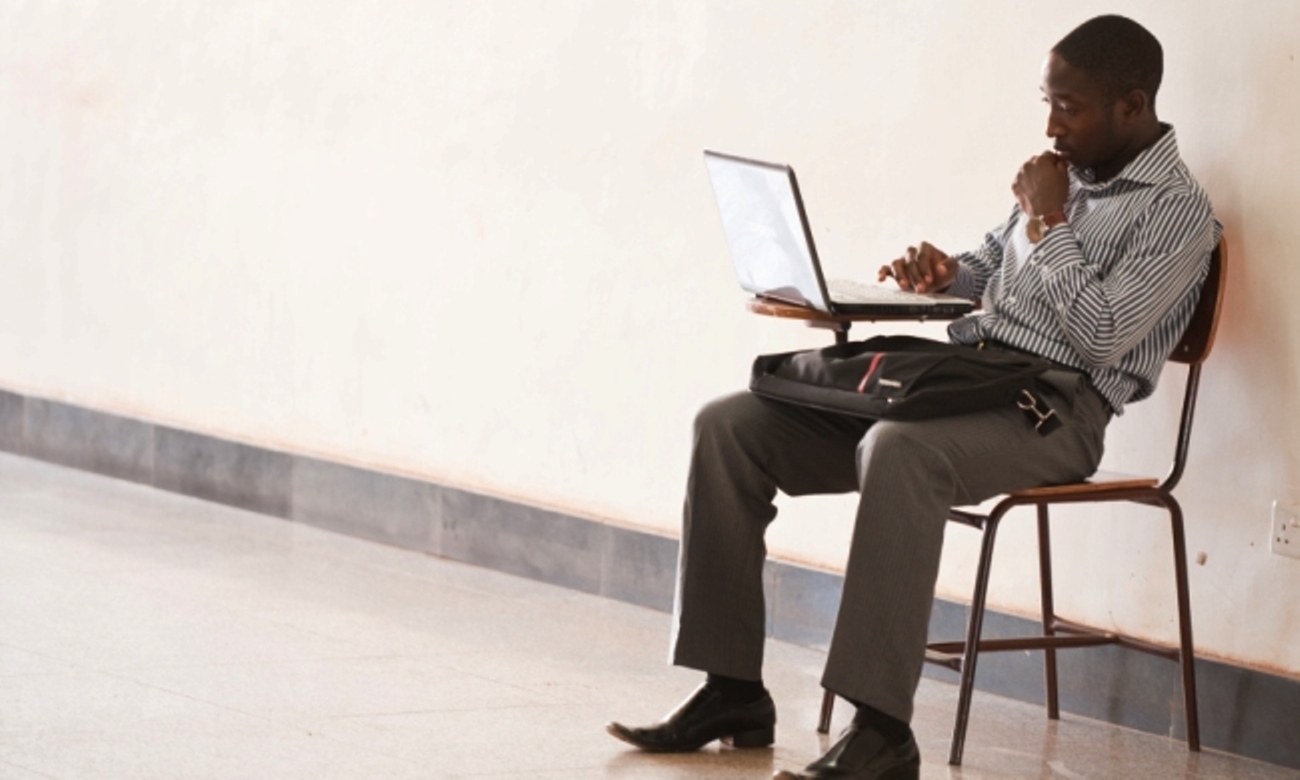 A male student studies on his laptop in the College of Computing and Information Sciences (CoCIS), Block B, Makerere University, Kampala Uganda.