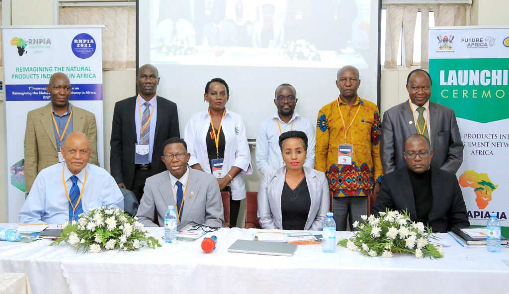Seated L-R: Fmr. Chancellor-Prof. Mondo Kagonyera, Director DRGT-Prof. Buyinza Mukadasi, Convener-Dr Alice Nabatanzi and Representative of the DVCAA-Prof. Christopher Mbazira with Dep. Principal CoNAS-Prof. Fredrick Muyodi (Standing R) and representatives from partner institutions at the 1st NAPIANA Symposium on 17th January 2022, Makerere University.