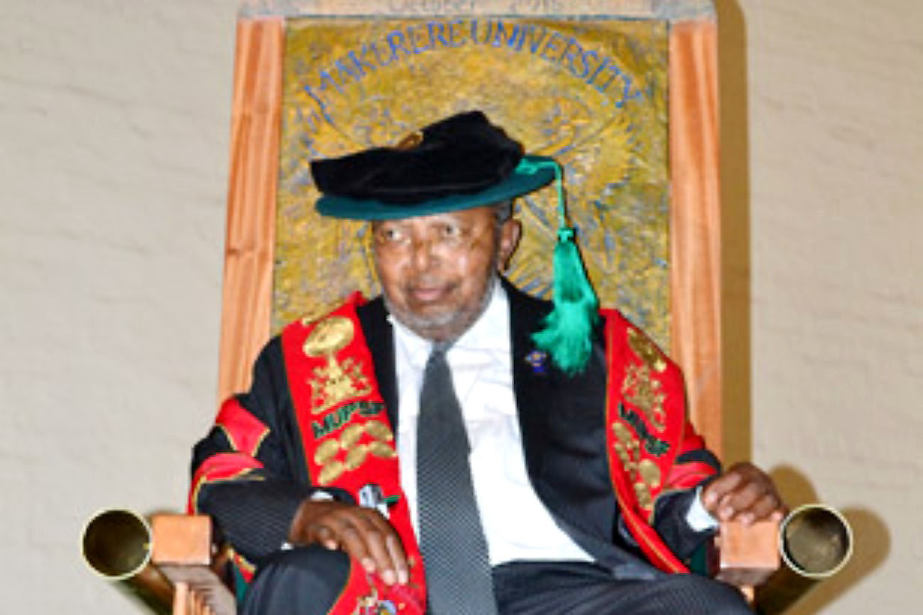 Prof. Emmanuel Tumusiime-Mutebile sits upon the symbolic Chair of Monetary Policy, Banking and Finance during the installation ceremony on 27th October 2015, Main Hall, Makerere University.