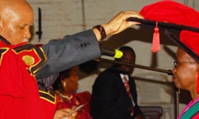 The Chancellor, Prof. Mondo Kagonyera (L) confers a PhD upon one of the female graduands on 22nd July 2011 in the Main Hall, Makerere University.