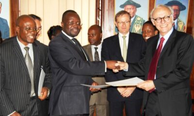 Prof. Venansius Baryamureeba (2nd L) exchanges the signed MoU with the representative of Total Professeurs Associes (TPA) (R) on 15th May 2012 at Makerere University. Left is the Senior Legal Officer Mr. Goddy Muhumuza while 3rd Right (Rear) is General Manager Total E & P Uganda, Loic Laurandel.