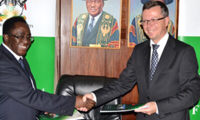 The Vice Chancellor Makerere University Prof. John Ddumba-Ssentamu (L) exchanges the signed Frame Agreement with The Rector University of Bergen, Prof. Dag Rune Olsen on 30th September 2014 at Makerere University.