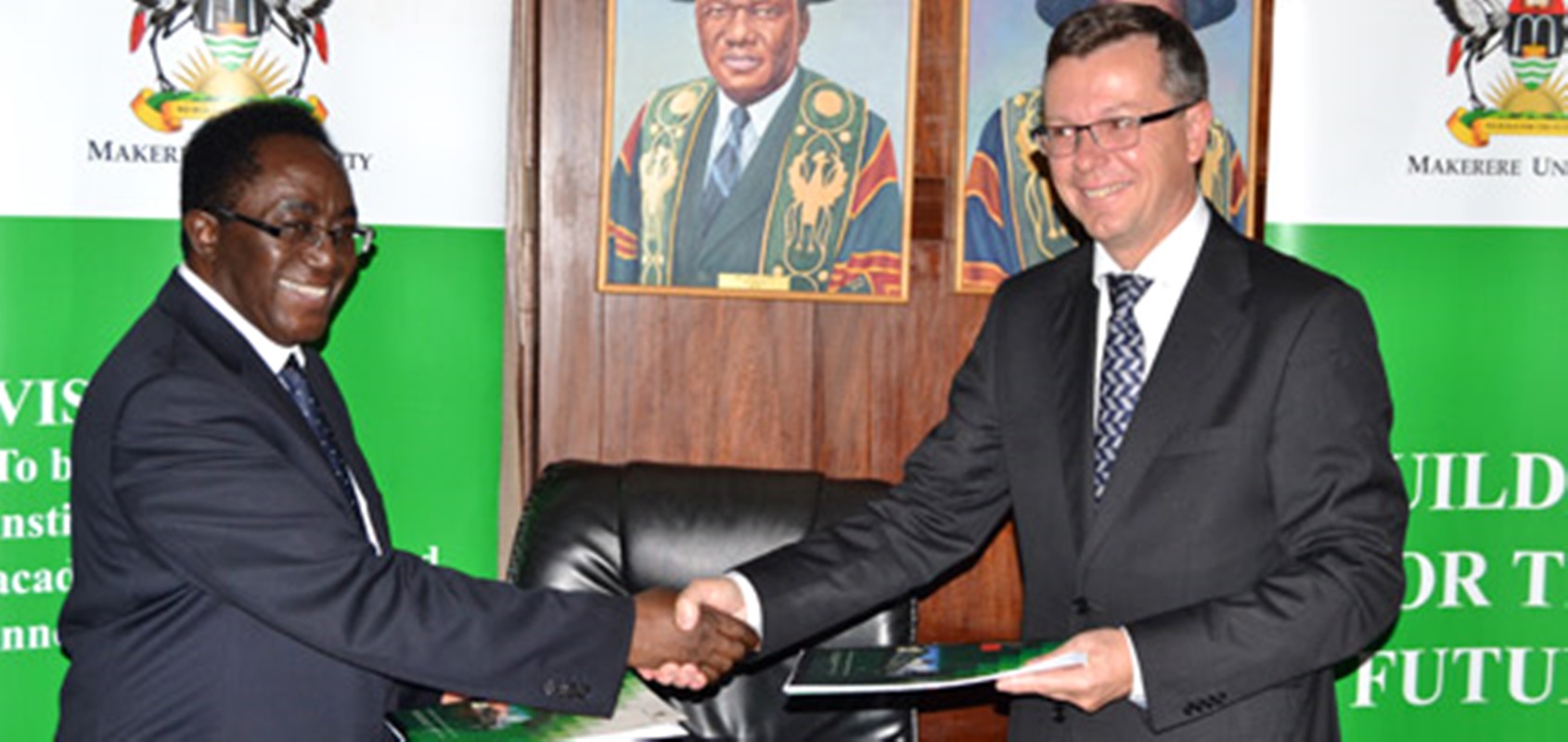 The Vice Chancellor Makerere University Prof. John Ddumba-Ssentamu (L) exchanges the signed Frame Agreement with The Rector University of Bergen, Prof. Dag Rune Olsen on 30th September 2014 at Makerere University.