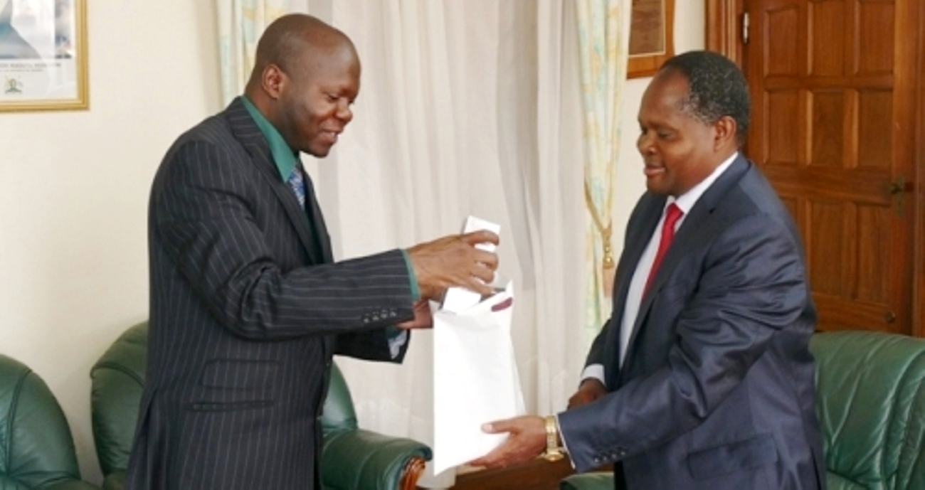 Acting Vice Chancellor and DVCAA Assoc. Prof. Ernest Okello Ogwang (L) hands over branded Makerere items to UoNBI Vice Chancellor Prof. Peter Mulwa Felix Mbithi after the 28th August 2015 courtesy call, Makerere University, Kampala Uganda.