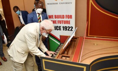Prof. Hugh Rowell plays a tune on the Harpsichord as the Vice Chancellor, Prof. Barnabas Nawangwe listens shortly after he handed over the instrument on 27th January 2022 in the Council Room, CTF1, Makerere University.