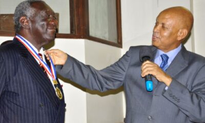 The Chancellor,Prof. Mondo Kagonyera (R) decorates H.E. John Agyekum Kufuor (L) with a medallion in appreciation of his public lecture on 2nd August 2013, Makerere University, Kampala Uganda.