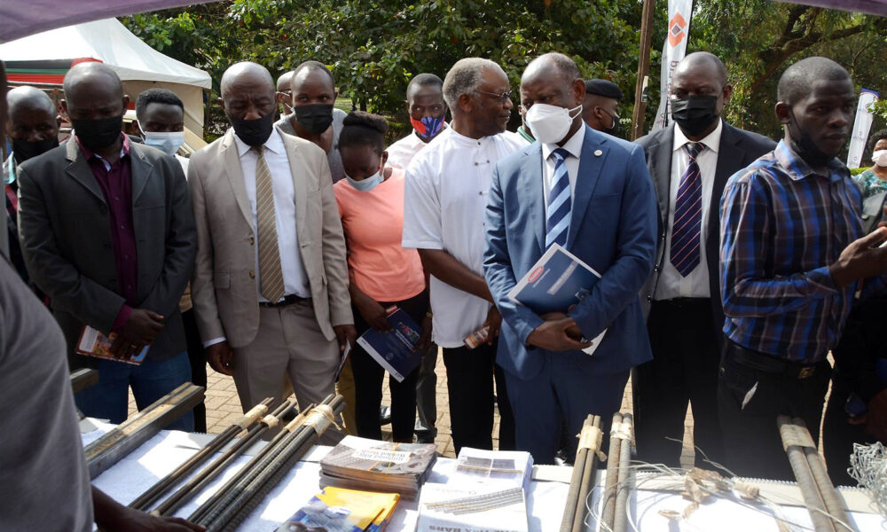 The Vice Chancellor, Prof. Barnabas Nawangwe (3rd R) flanked by the Principal CEDAT-Prof. Henry Alinaitwe (2nd L), Head Department Architecture and Physical Planning-Dr. Tamale Kiggundu Amin (2nd R), Architects and Fundis inspects one of the exhibition stands at the launch of the two-day training on 9th February 2022, CEDAT, Makerere University.